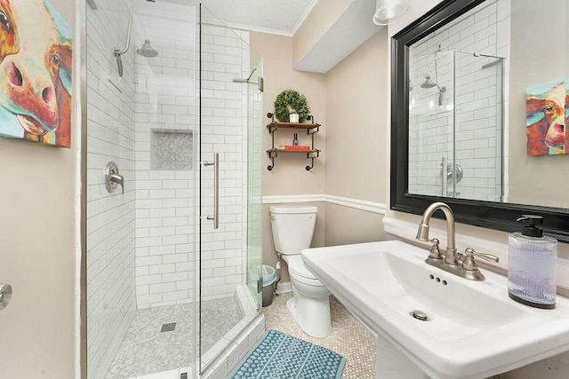 bathroom featuring walk in shower, ornamental molding, toilet, and sink