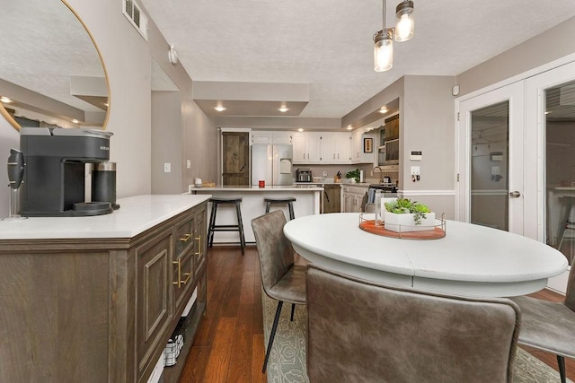 dining space with dark hardwood / wood-style flooring