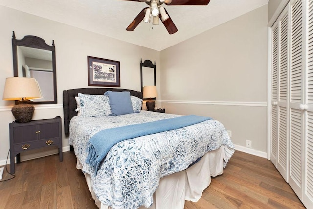 bedroom featuring ceiling fan, wood-type flooring, and a closet