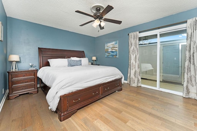 bedroom featuring ceiling fan, access to outside, a textured ceiling, and light wood-type flooring