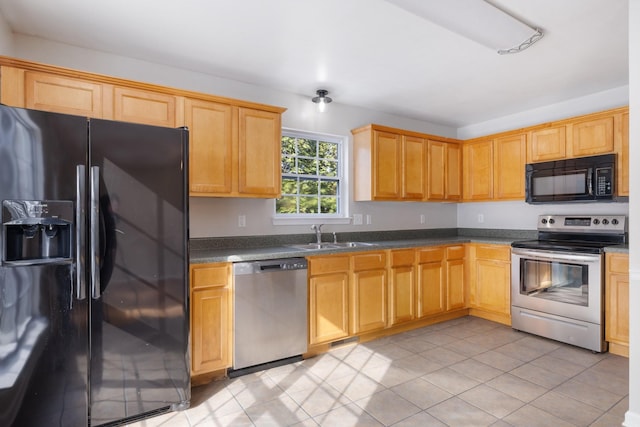 kitchen featuring light tile patterned floors, sink, and black appliances