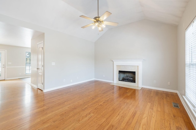 unfurnished living room featuring vaulted ceiling, ceiling fan, and light hardwood / wood-style flooring