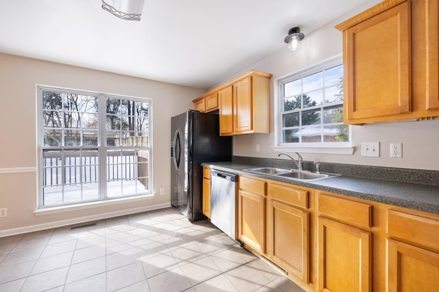 kitchen with sink, stainless steel dishwasher, black fridge with ice dispenser, and light tile patterned floors