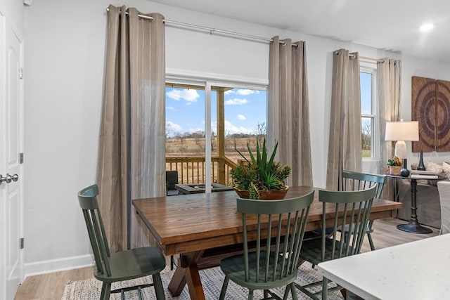 dining space with light hardwood / wood-style flooring