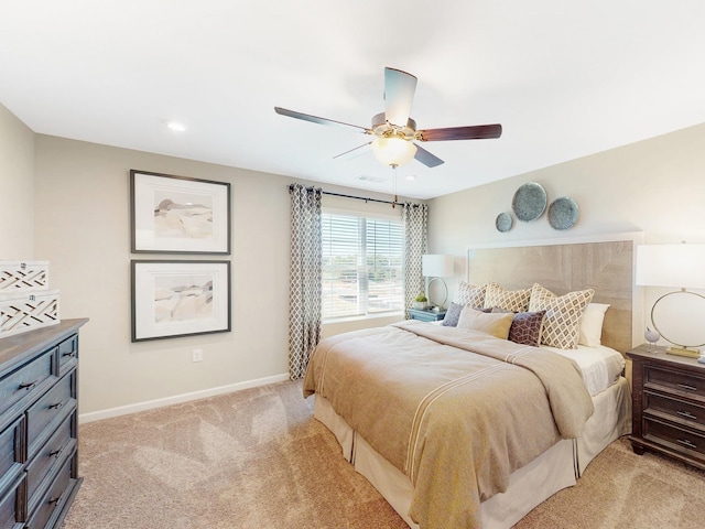 bedroom with ceiling fan and light colored carpet