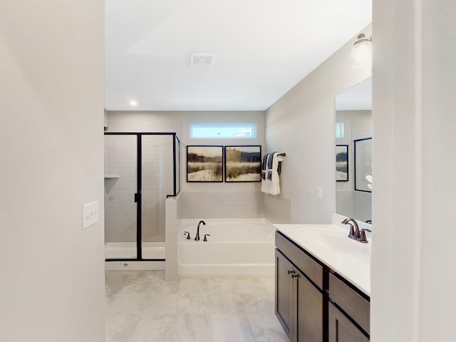 bathroom featuring vanity, shower with separate bathtub, and tile patterned flooring