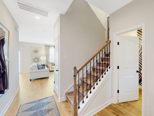 stairway featuring wood-type flooring