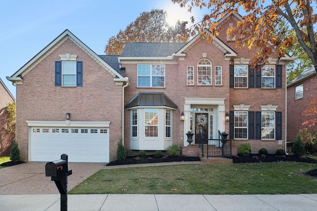 view of front of house featuring a garage and a front yard