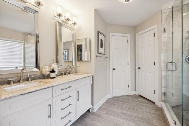 bathroom featuring vanity and an enclosed shower