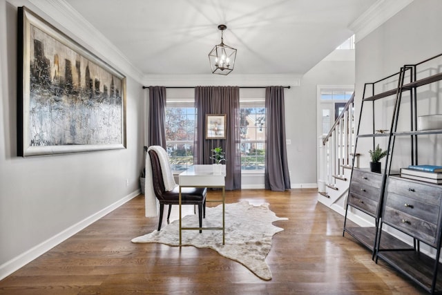 dining area with hardwood / wood-style floors, ornamental molding, and a chandelier