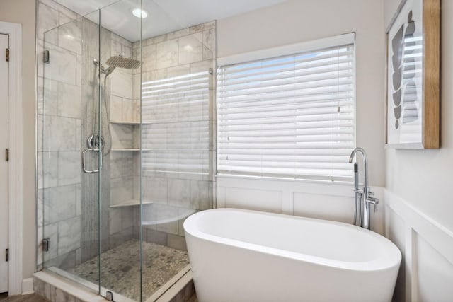 bathroom with separate shower and tub