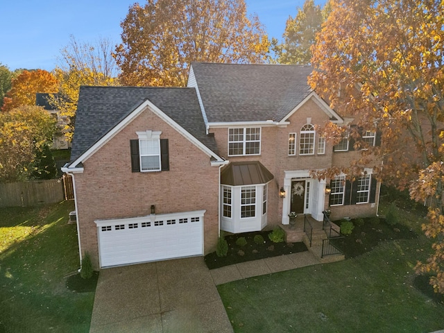 view of front of home featuring a garage and a front lawn