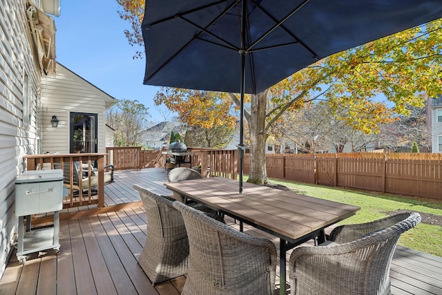 wooden deck featuring a lawn