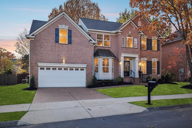 view of front facade featuring a garage and a lawn