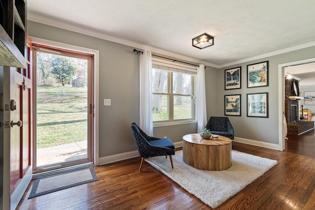 living area with crown molding and dark hardwood / wood-style flooring