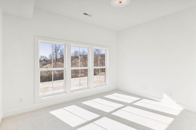 unfurnished room featuring light carpet