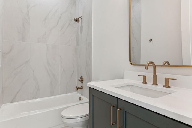 full bathroom featuring tiled shower / bath combo, vanity, and toilet