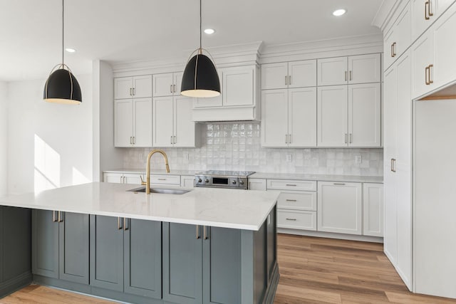 kitchen with white cabinetry, sink, and decorative light fixtures