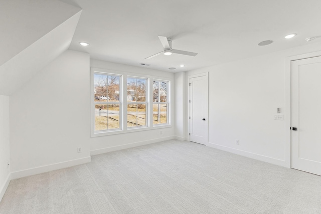 bonus room with vaulted ceiling, light colored carpet, and ceiling fan