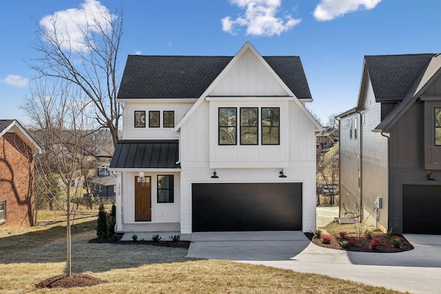 modern inspired farmhouse featuring a garage and a front lawn