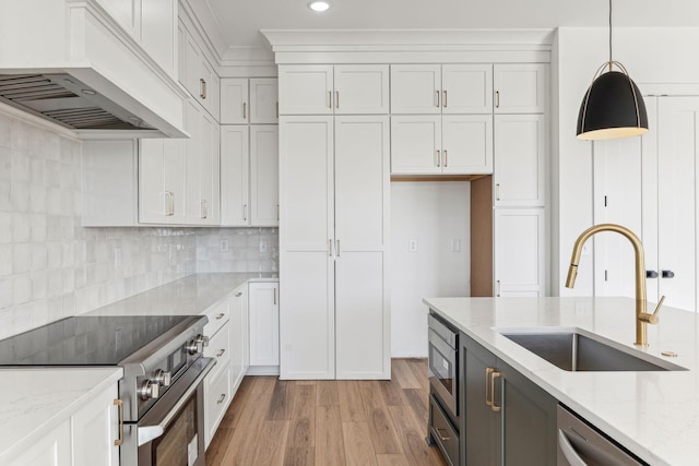 kitchen with stainless steel appliances, custom exhaust hood, hanging light fixtures, and white cabinetry