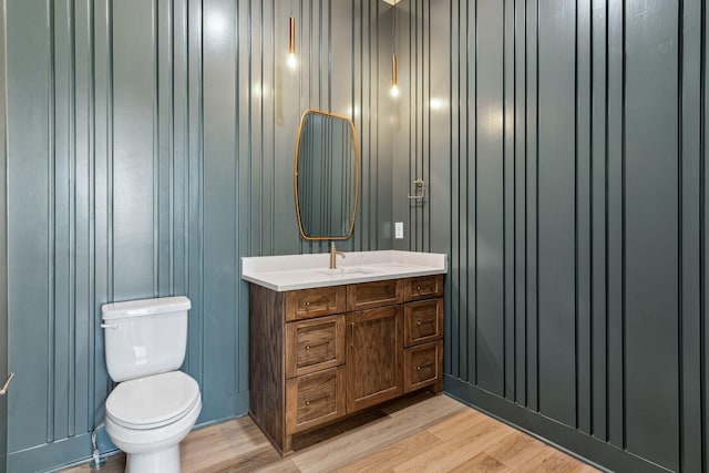 bathroom with vanity, hardwood / wood-style flooring, and toilet