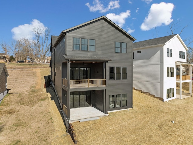 rear view of house with a patio and a lawn