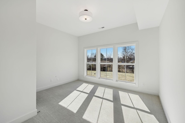 unfurnished room with light carpet