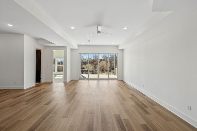 unfurnished living room with ceiling fan and wood-type flooring