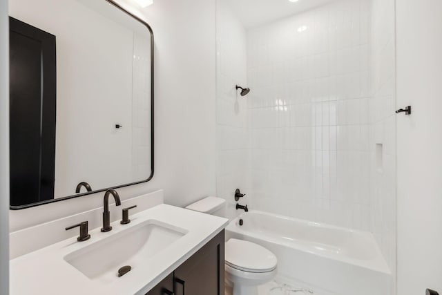 full bathroom with tiled shower / bath, vanity, and toilet