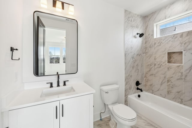 full bathroom with vanity, toilet, and tiled shower / bath combo