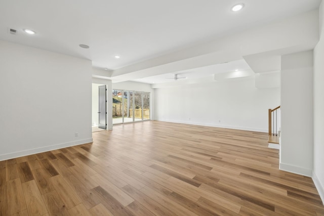 empty room with ceiling fan and light wood-type flooring