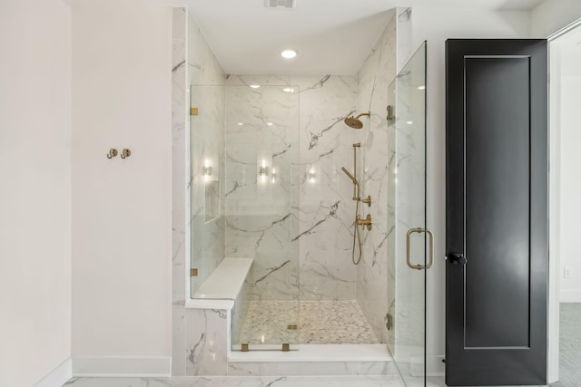 bathroom featuring a shower with door