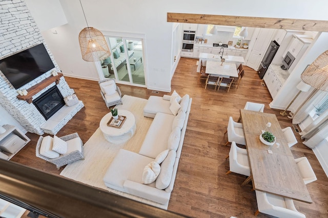 living room with sink, a fireplace, and dark hardwood / wood-style floors