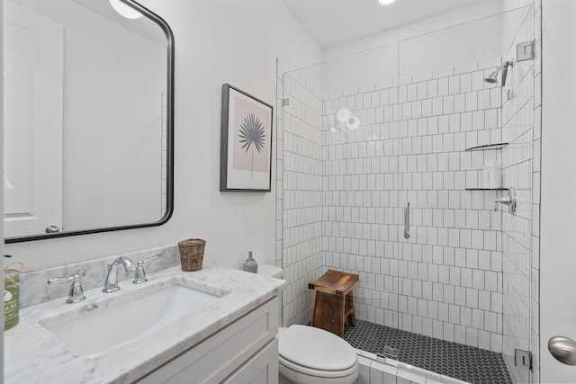 bathroom with vanity, an enclosed shower, and toilet