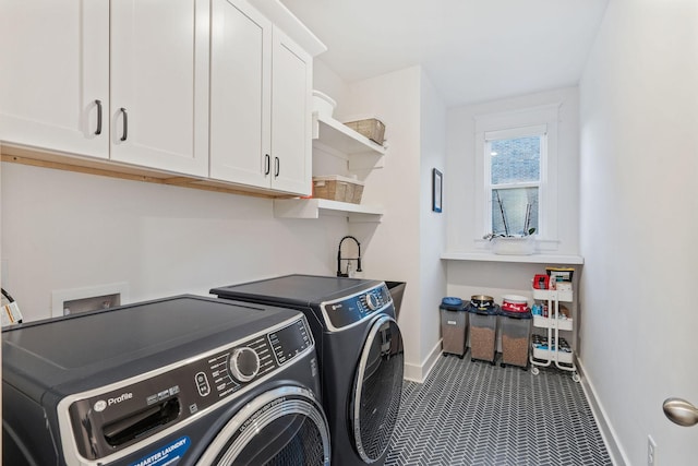 clothes washing area with cabinets, separate washer and dryer, and sink