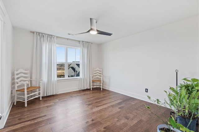 empty room with dark hardwood / wood-style flooring and ceiling fan