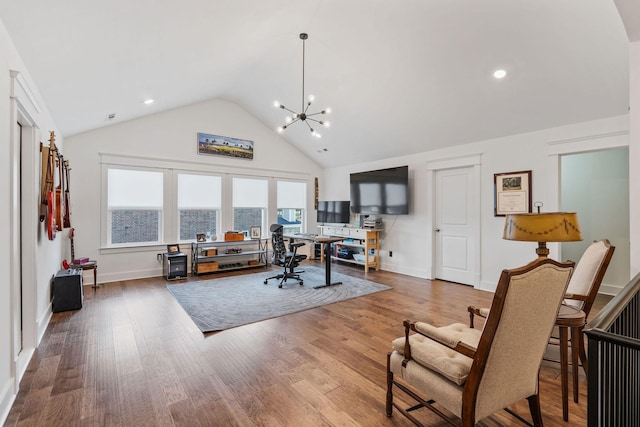 office space featuring an inviting chandelier, hardwood / wood-style flooring, and high vaulted ceiling