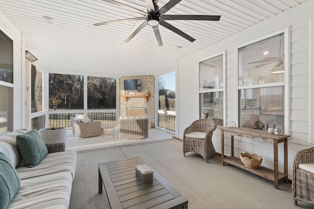 sunroom featuring wood ceiling and ceiling fan