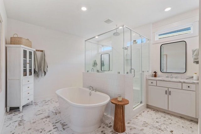 bathroom with vanity and shower with separate bathtub