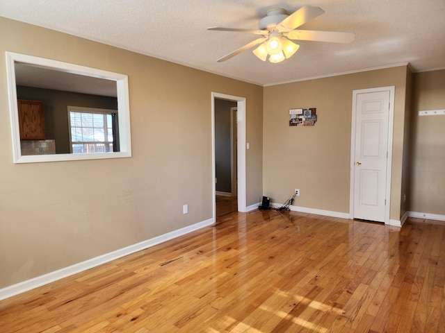 unfurnished room with crown molding, light hardwood / wood-style flooring, a textured ceiling, and ceiling fan