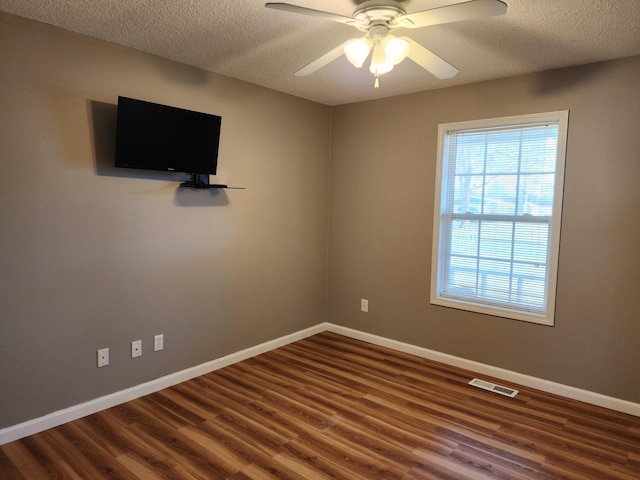 unfurnished room featuring hardwood / wood-style flooring, ceiling fan, and a textured ceiling