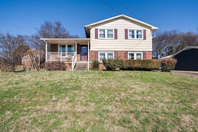 split level home featuring a front lawn and covered porch