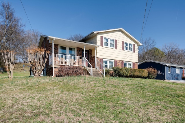 tri-level home with a carport, covered porch, and a front lawn