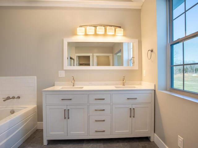 bathroom featuring vanity and a washtub