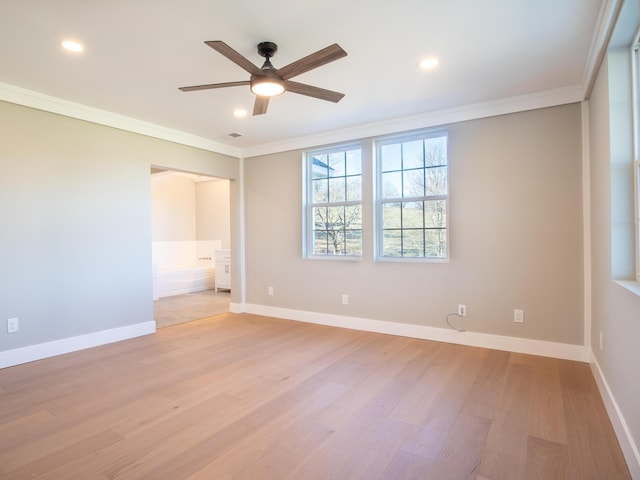 spare room featuring crown molding, light hardwood / wood-style floors, and ceiling fan