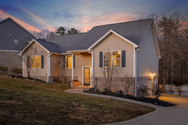 view of front of house featuring a garage and a lawn