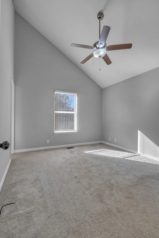 spare room with ceiling fan, carpet flooring, and high vaulted ceiling