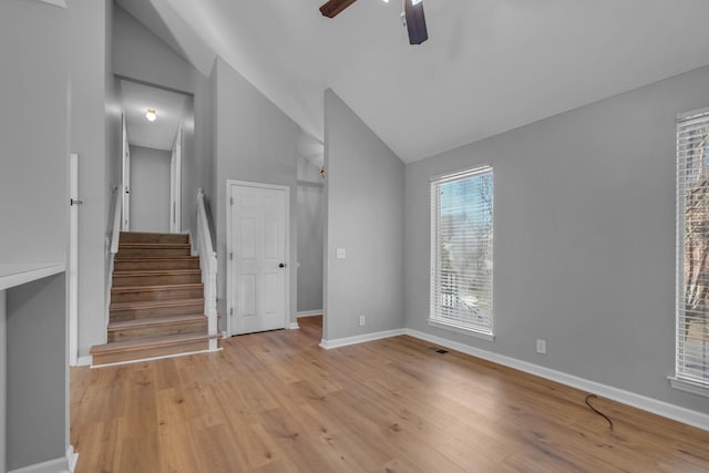 unfurnished living room with ceiling fan, lofted ceiling, and light hardwood / wood-style floors