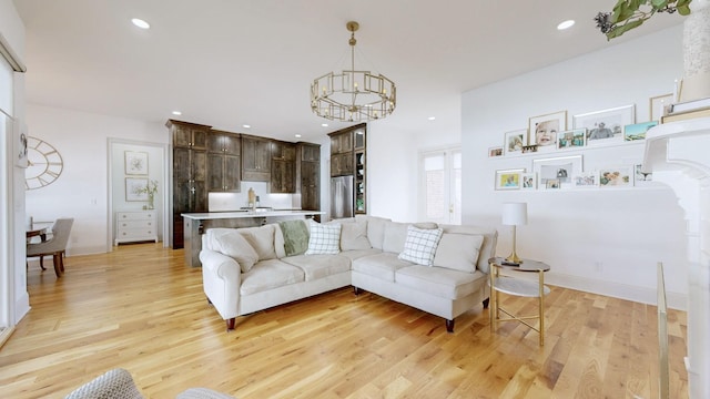 living room featuring light hardwood / wood-style floors and a chandelier